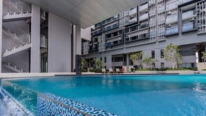 A modern building with a swimming pool, outdoor seating, and a staircase. - Imperio Seaview Melaka By I Housing (Malacca City)