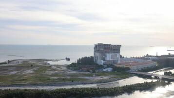 A coastal building with a waterfront view, a bridge, and a river.