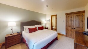 Relax in comfort with a large bed, nightstand, and wardrobe, perfect for a restful stay.