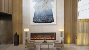 A modern lobby with a large abstract painting, a fireplace, and two armchairs. - Holiday Inn Dalian Hot Spring by IHG (Dalian)