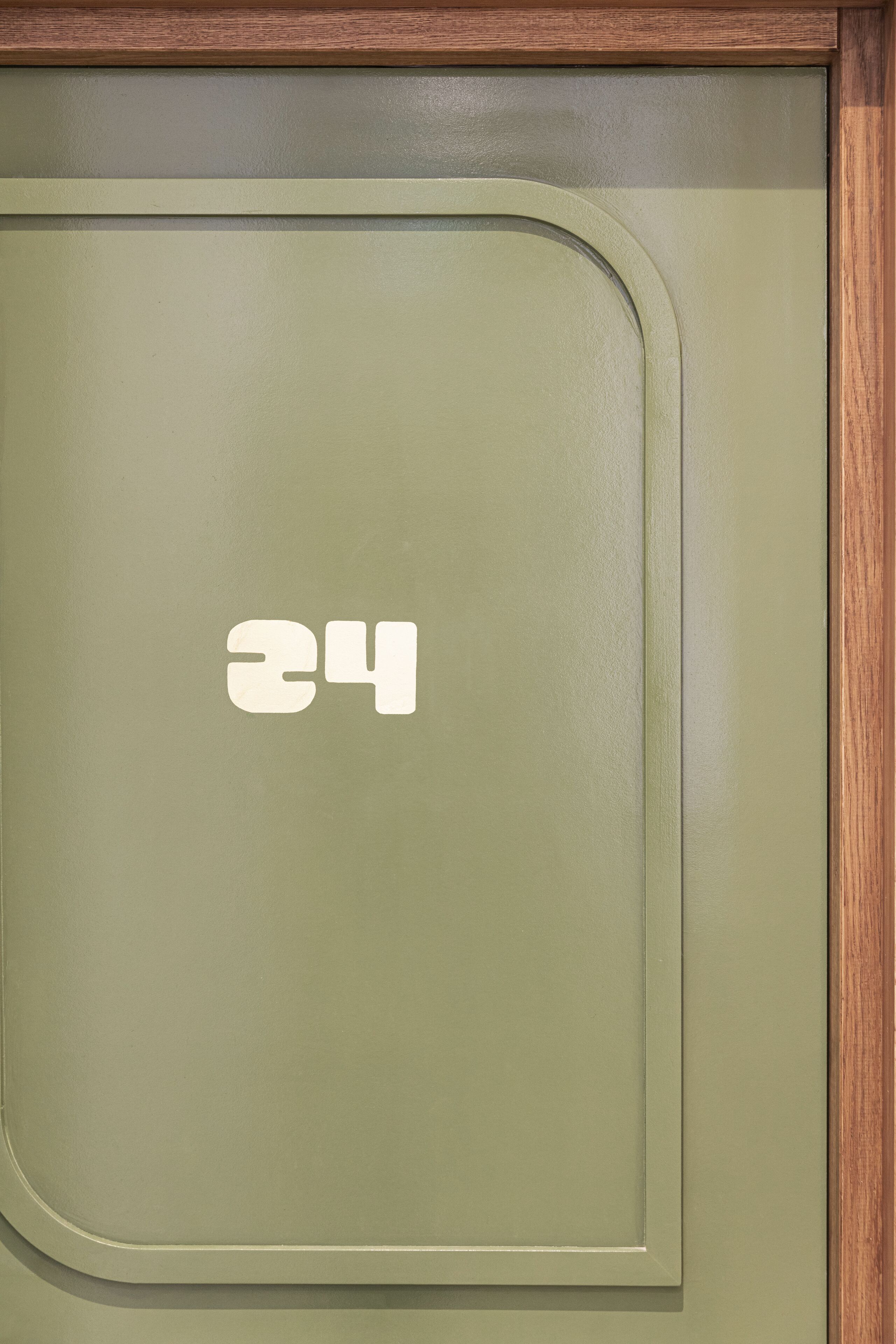 A door with a number '24' and a wooden frame.