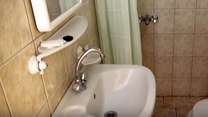 Ein Badezimmer mit Waschbecken, Spiegel und Toilette.