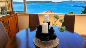 A dining table with candles and a view of the sea. - Apartment With Breathtaking sea View (Trogir)