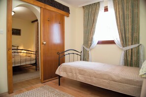 A bedroom with a single bed, a wooden wardrobe, a small window with curtains, and a door leading to another room. - House With Pool in Split Near the Beach (Split)