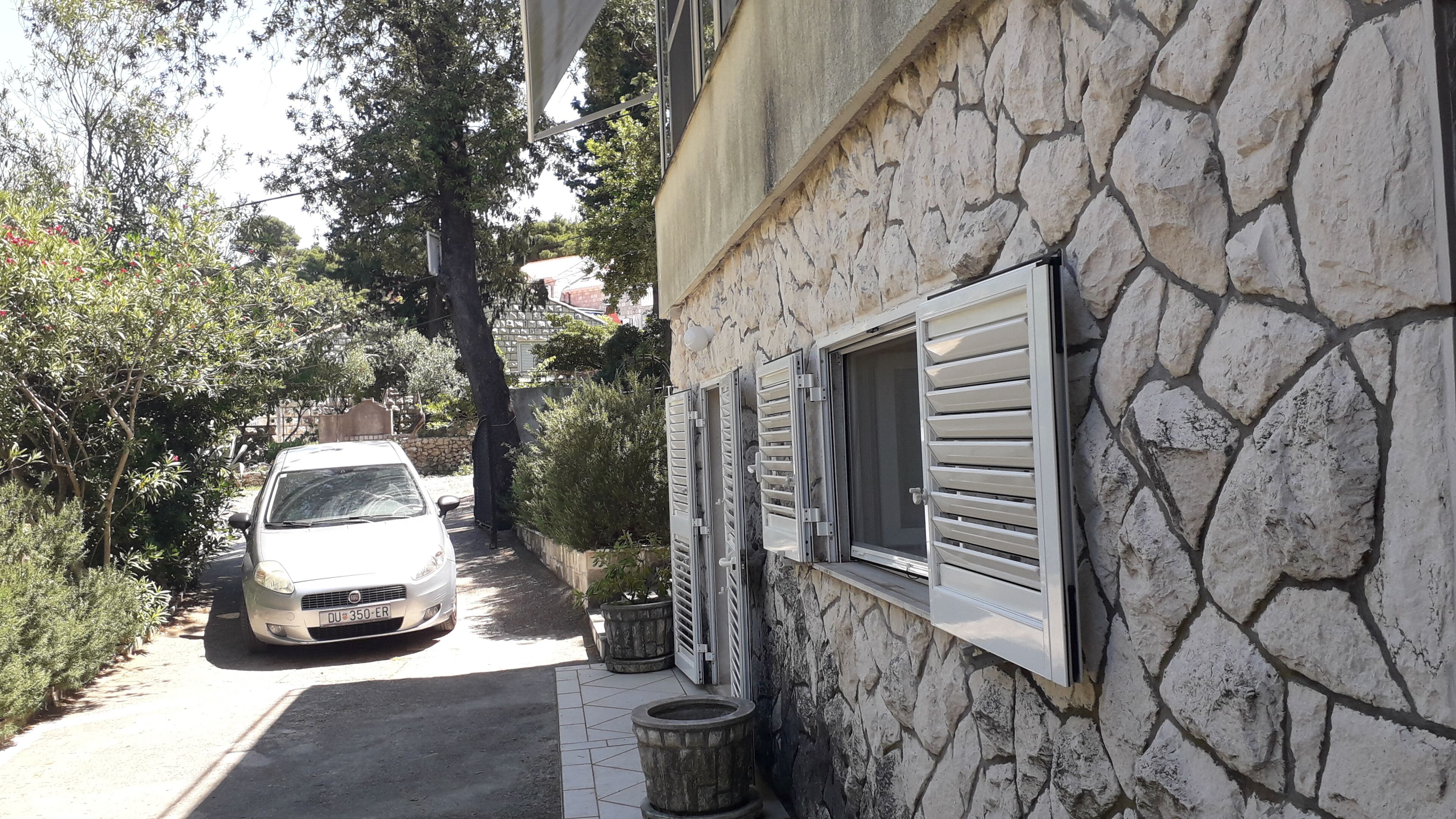 A stone building with a car parked in front.