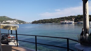 A clear view of a body of water with boats, a table with a tablecloth, and a railing. - Room-the Most Beautiful Position in Zato (Dubrovnik)