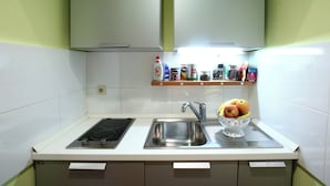 A kitchen with a stove, sink, and a fruit bowl on the counter. - Double Bedroom Apartment on Great Location With Balcony!! (Split)