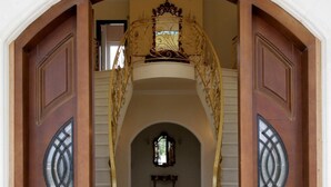 A grand entrance with a marble floor and ornate doors. - Luxurious Villa Anthi (Chania)