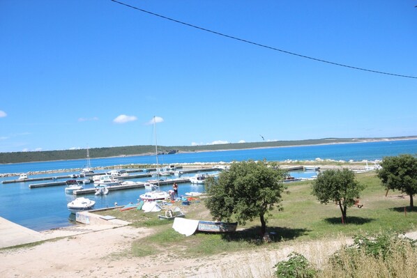 Boats docked at the marina, surrounded by lush greenery and calm waters.
