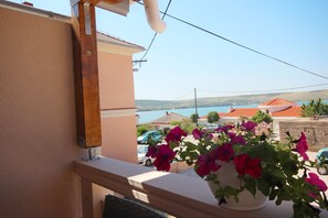 Enjoy the breathtaking view of the coastal town from this balcony.
