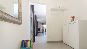 A hallway with a patterned bench, a wardrobe, and a mirror on the wall. - In Center Near the Marina and Beach With Amazing View (Tribunj)
