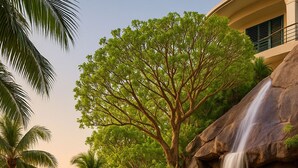 A pool with a waterfall, surrounded by palm trees and a gazebo. - Truly one of the Finest Villa for Rent in Puerto Vallarta (Puerto Vallarta)