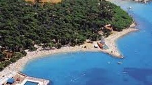 An aerial view of a coastal area with a small island, clear blue waters, and a boat in the distance. - Cozy Apartment in Biograd for Maximum 4 Guests - 3 Minutes Walk to the Beach! (Biograd na Moru)