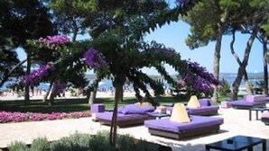 An outdoor seating area with purple and yellow cushions, surrounded by trees and a clear sky. - Cozy Apartment in Biograd for Maximum 4 Guests - 3 Minutes Walk to the Beach! (Biograd na Moru)