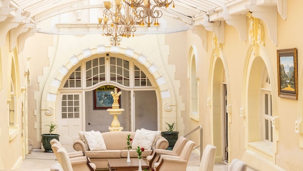 A spacious, elegantly furnished lounge with a high ceiling and ornate chandeliers. - King Edward Hotel (Port Elizabeth)