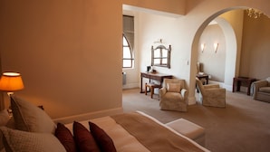 A bedroom with a bed, a desk, and two armchairs. - King Edward Hotel (Port Elizabeth)