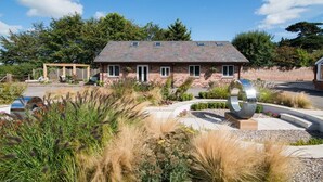 A two-story brick house with a sloped roof and skylights. - Super Spacious Barn Conversion With Free Wifi, Netflix Fireplace (Chester)