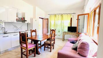 Apartment, 2 Bedrooms | Living area | 22-inch flat-screen TV with cable channels
