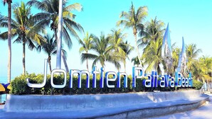 A sign with the text "Jomien Pattaya Beach" surrounded by palm trees and a clear sky. - Jomtien Beach Condominium 5th Floor Modern Studio Apartment Pattaya (Pattaya)