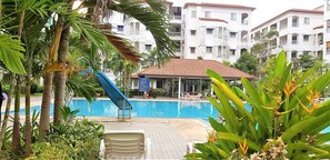 Relax by the pool surrounded by lush tropical vegetation and enjoy a refreshing swim or a thrilling slide.