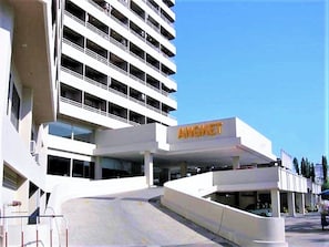 A multi-story building with a prominent 'ANGKET' sign on the facade.