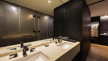 A modern bathroom with a large vanity, two sinks, and a mirror.