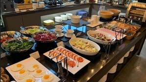A buffet with various food options including salads, eggs, and meats. - Mercure Ambassador Seoul Hongdae (Seoul)