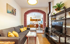 Relax in this stylish living room with a sofa, coffee table, and flat-screen TV.