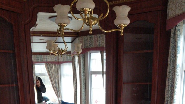 A formal dining room with a wooden table, six chairs with patterned upholstery, and a chandelier. - The Boat House Chalet - Boat of Garten - Near Aviemore - Sleeps 6 (Boat of Garten)