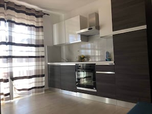 Enjoy cooking in this well-equipped kitchen with an oven and stainless steel range hood.