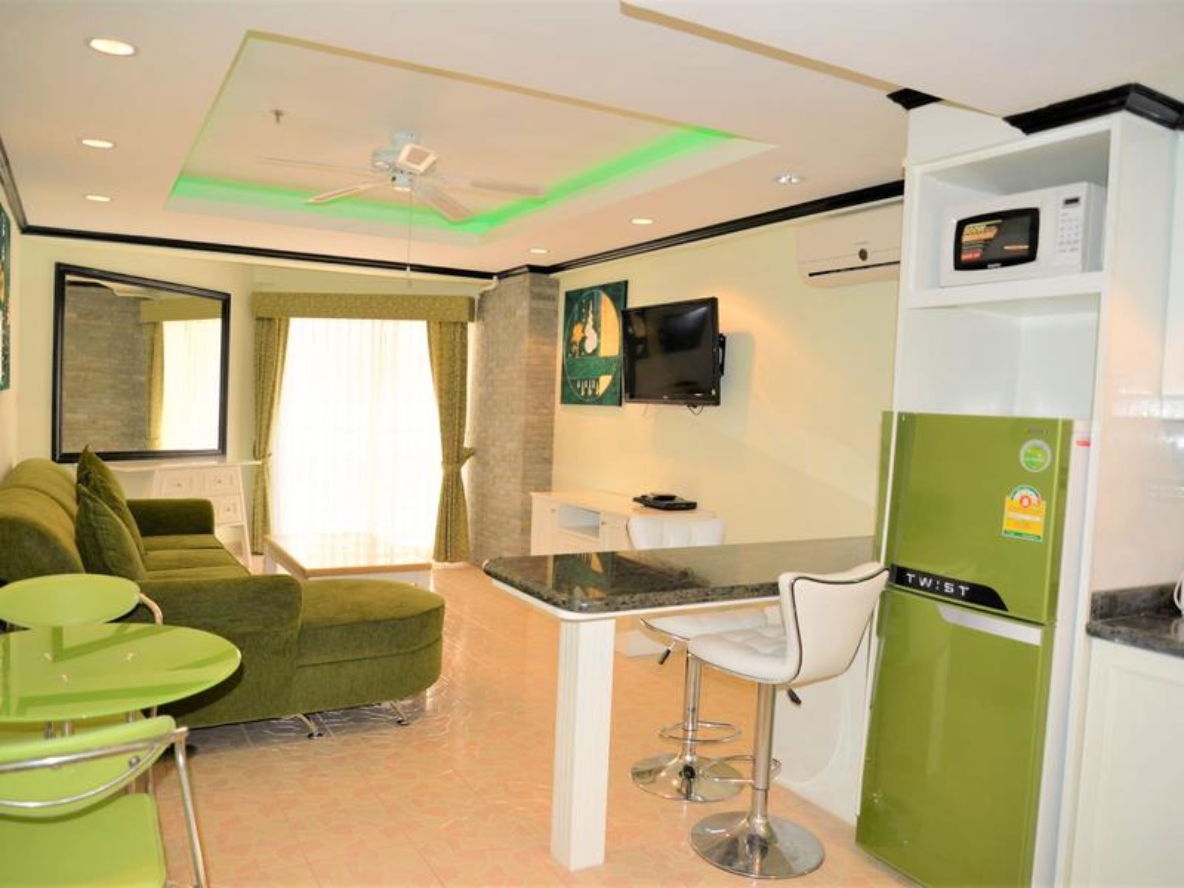 A compact living space with a kitchenette, a dining area, and a seating area.