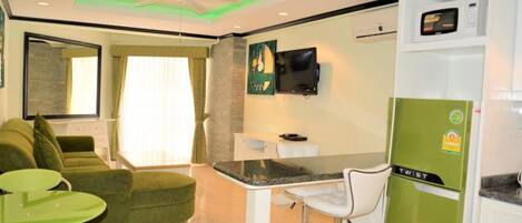 A compact living space with a kitchenette, a dining area, and a seating area.