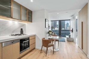 Fridge, microwave, oven, stovetop - Deluxe Collins St Apartment with City Views + Gym (Melbourne)
