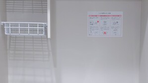 A kitchen with a stainless steel sink, a stove with a pot, and a white cabinet with two drawers. - ZAITO Tokyo Waseda Economy Inn (Tokyo)