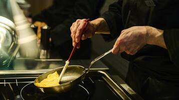 A person cooking an omelette on a stove.