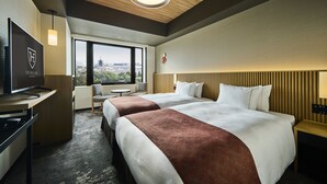 A hotel room with two beds, a desk with a TV, a chair, a view of the city, and a wooden ceiling. - The Royal Park Hotel Kyoto Umekoji (Kyoto)
