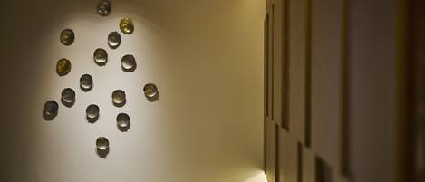 A wall with circular cutouts arranged in a pattern.