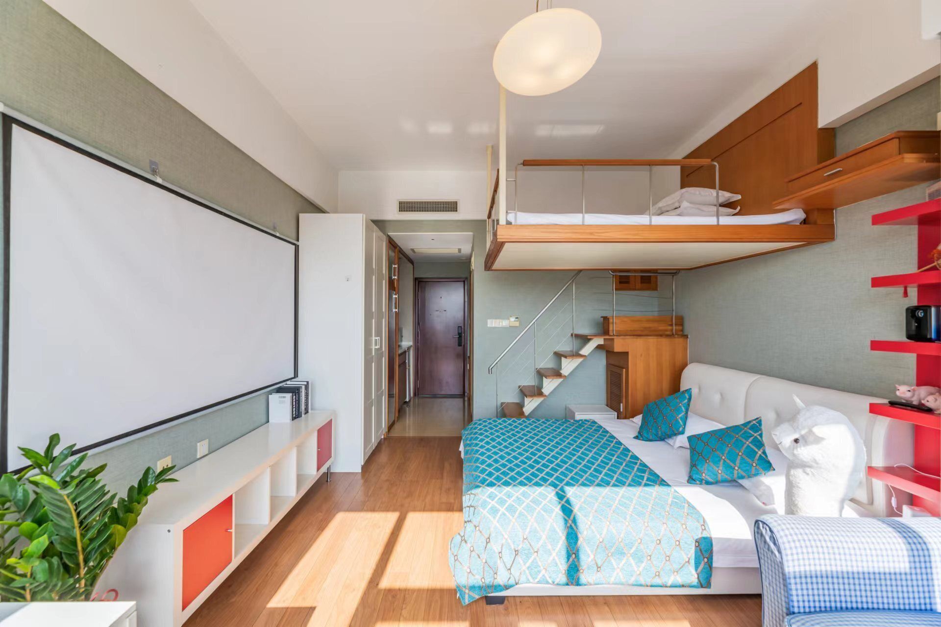 Un ambiente moderno e funzionale con una cuccetta, un divano e un angolo studio.
