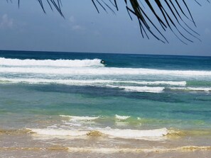 On the beach, white sand, sun-loungers, beach towels