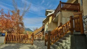 A residential building with a wooden staircase leading to a balcony.
