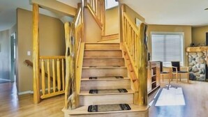 A wooden staircase with a handrail, leading to an upper floor.