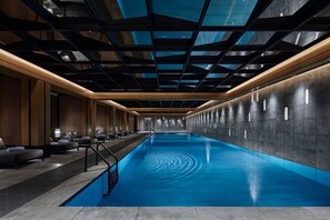 Una piscina al aire libre de temporada, tumbonas
