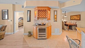 A spacious living area with a kitchen island, a dining table, and a seating area.