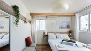 A hotel room with a bed, bedside table, and a window with a view. - Modern Loft Retreat with Rooftop by Sea N Rent (Tel Aviv)