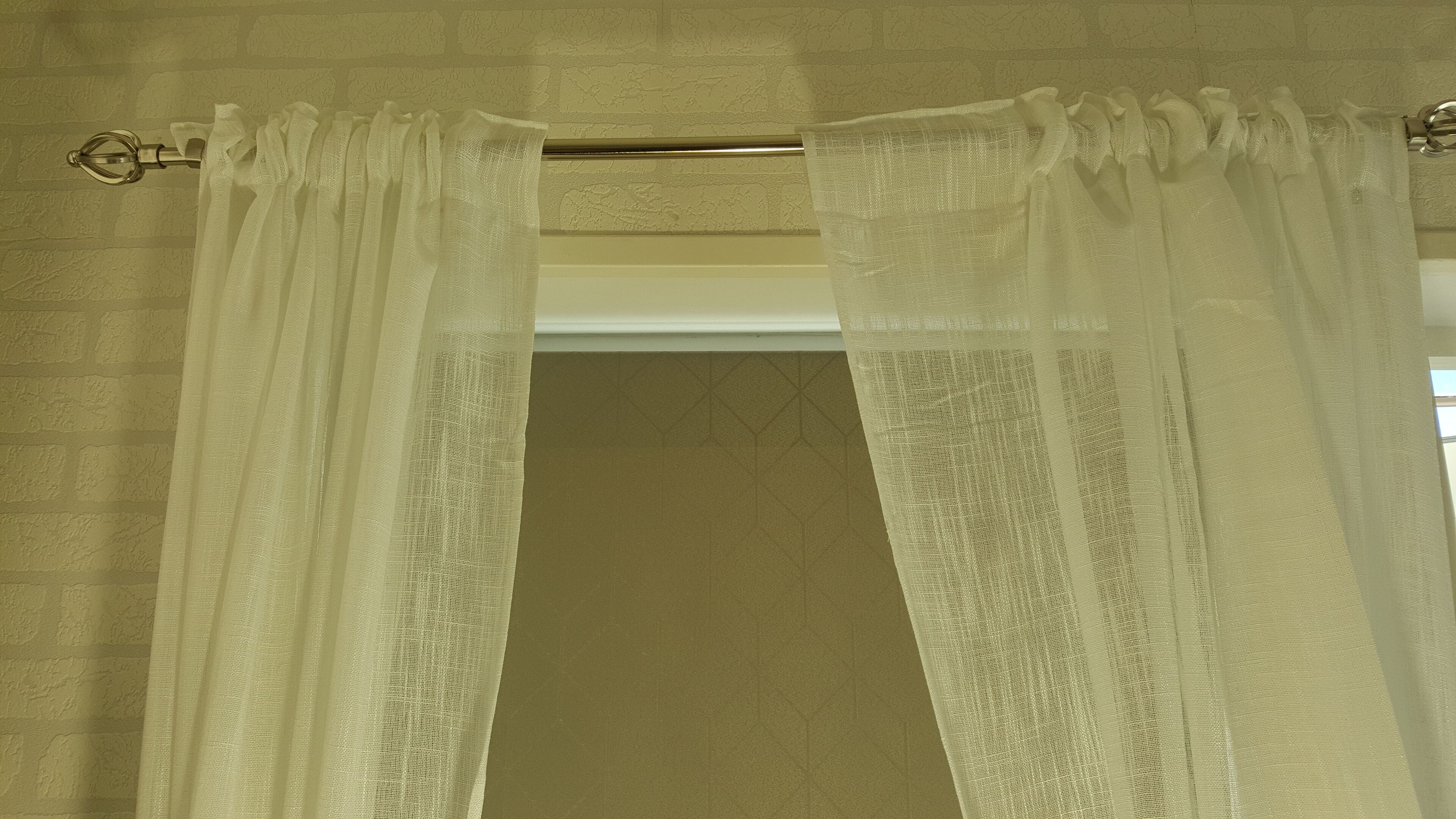 A bathroom with a shower curtain and a towel rack.