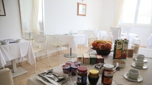 A breakfast buffet setup with various food items and utensils. - Beach Apartement - Studio Apartement - 2 Persons (Posedarje)