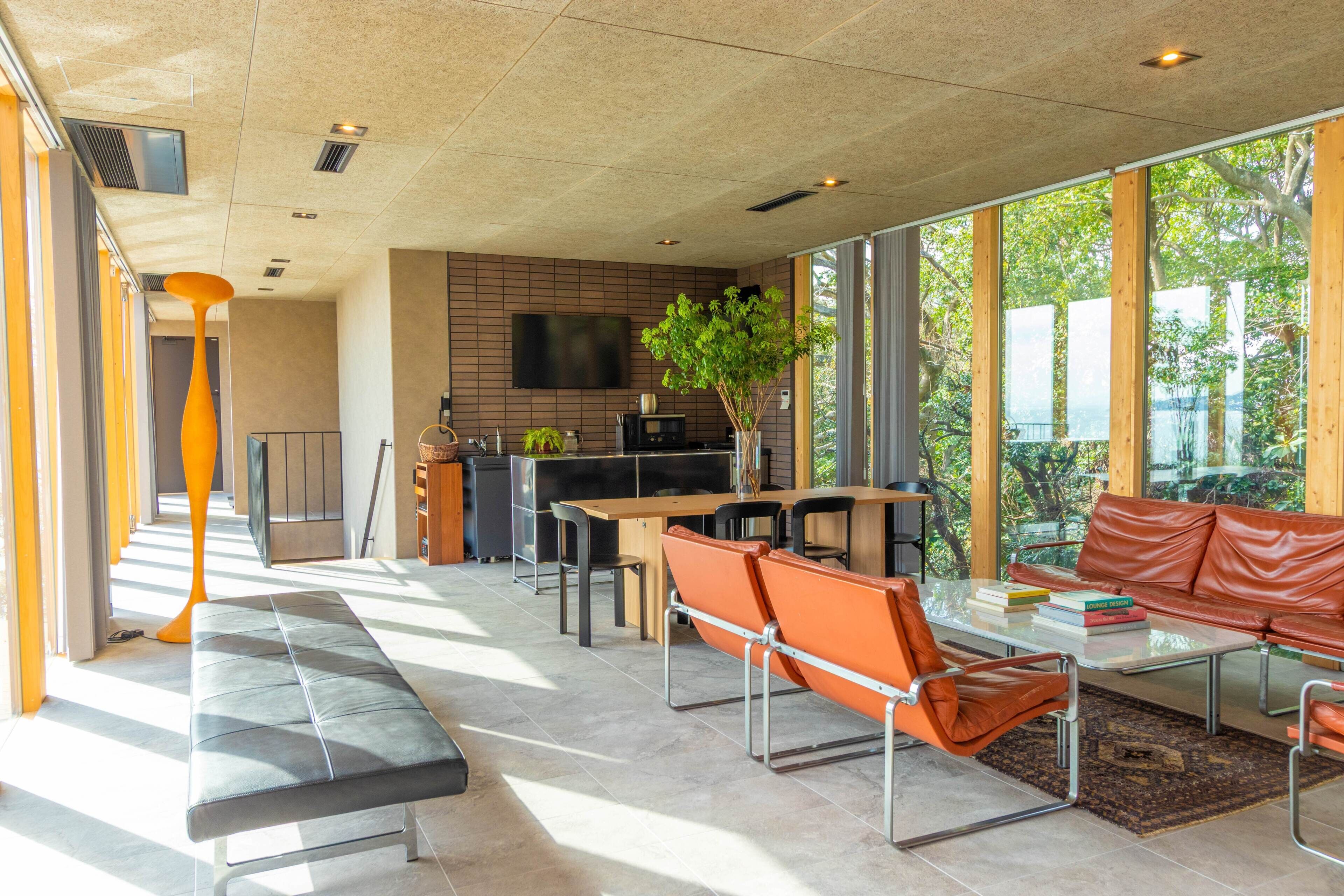 A modern interior with a kitchen, dining area, and seating.