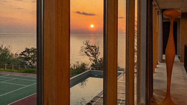A modern interior with a view of the sunset over the sea. - Kamome Slow Hotel (Awaji)