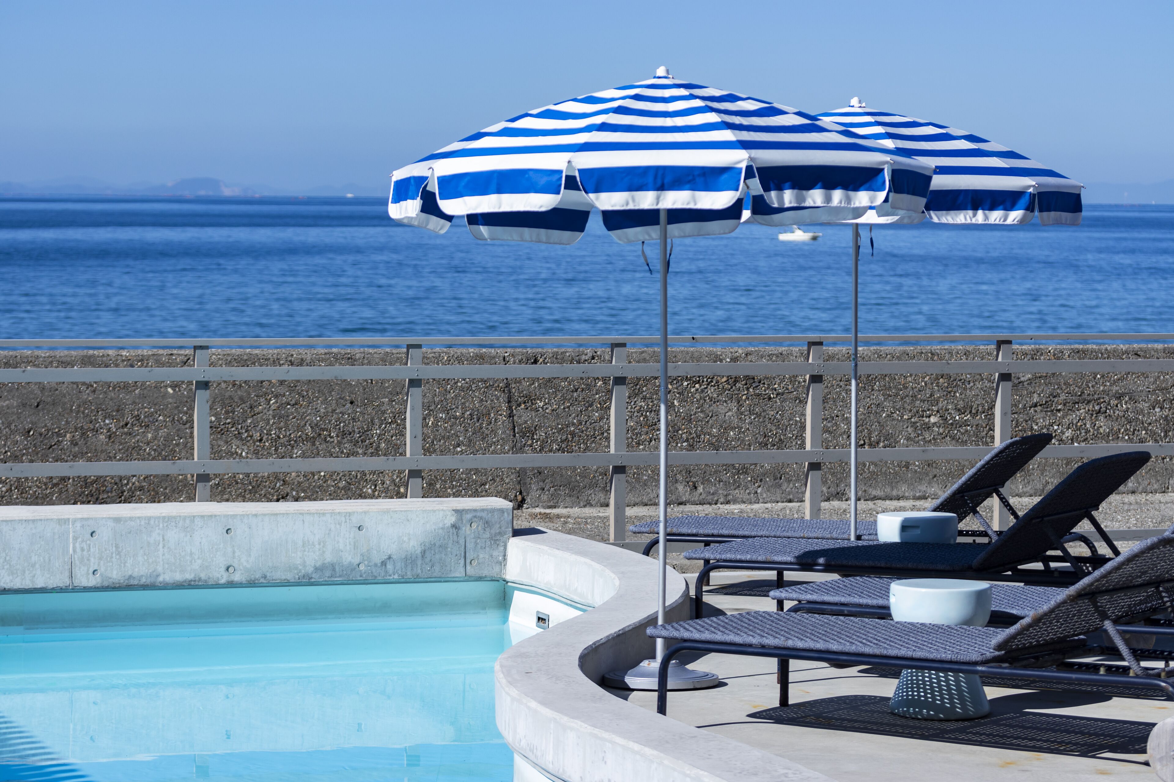 Alberca al aire libre, sombrillas en la alberca y camastros 