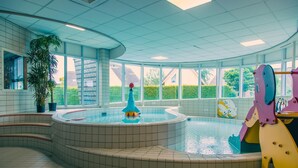 A swimming pool area with a circular design, a central fountain, and a play structure. - Beautiful House With Sauna Near Ijsselmeer (Medemblik)